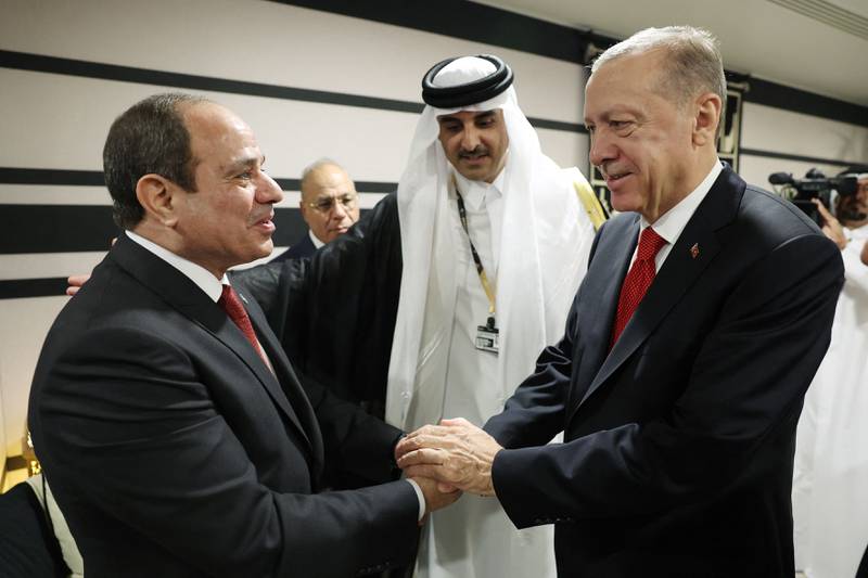 Turkish President Recep Tayyip Erdogan, right, greets Egyptian President Abdel Fattah El Sisi